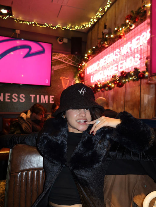 "The signature H" black bucket hat