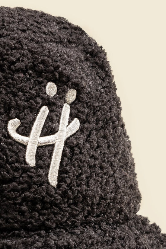 "The signature H" black bucket hat