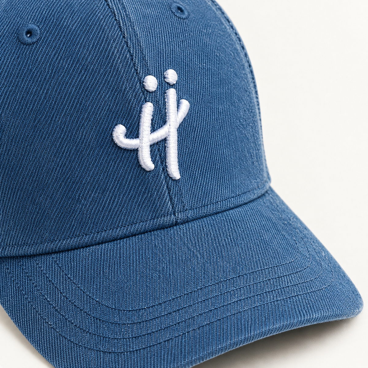 “The Signature H” washed denim